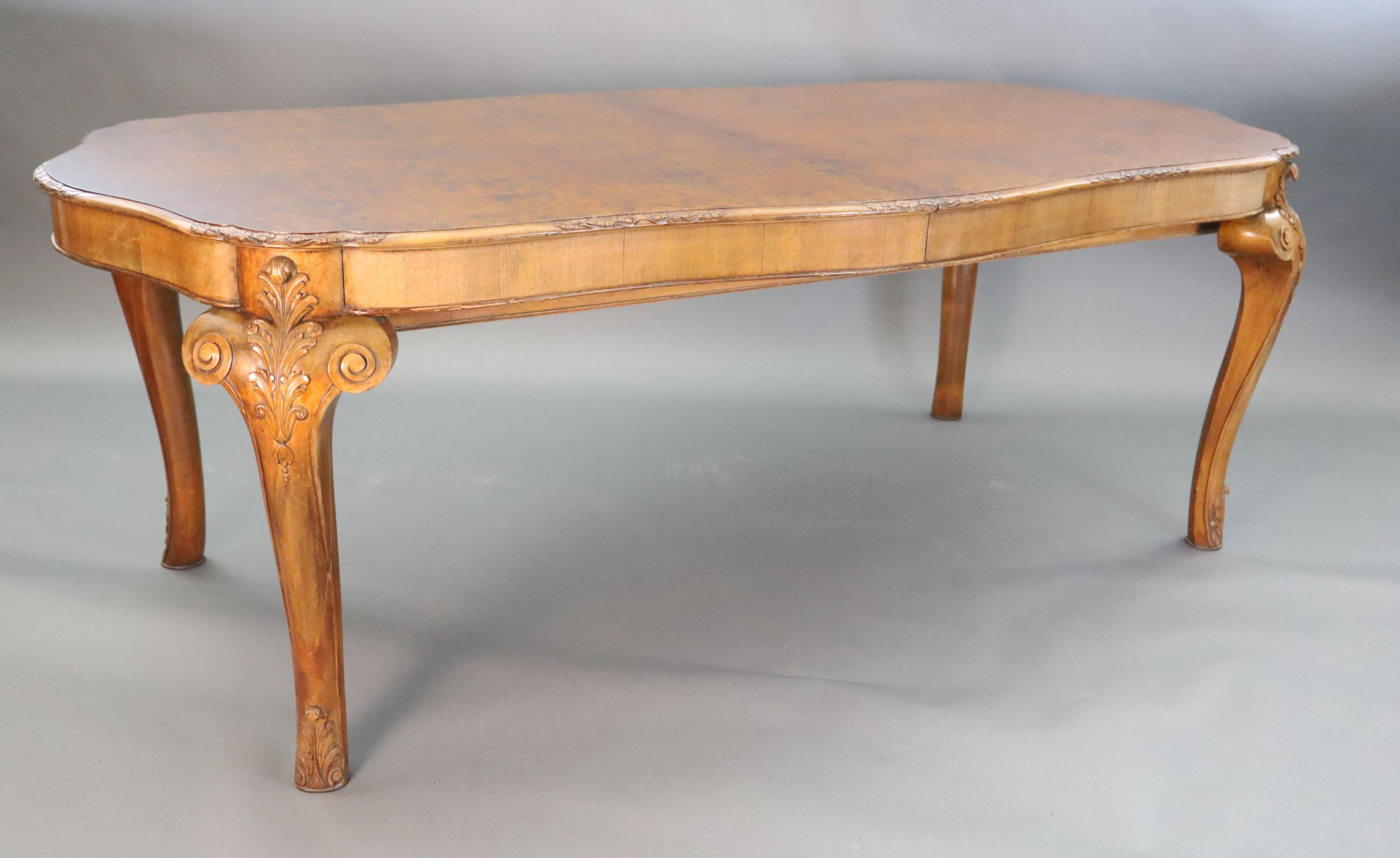 A Queen Anne style burr walnut extending dining table, W.3ft 5in. L.6ft 10in. extends to 8ft 10in. H.2ft 6in.
